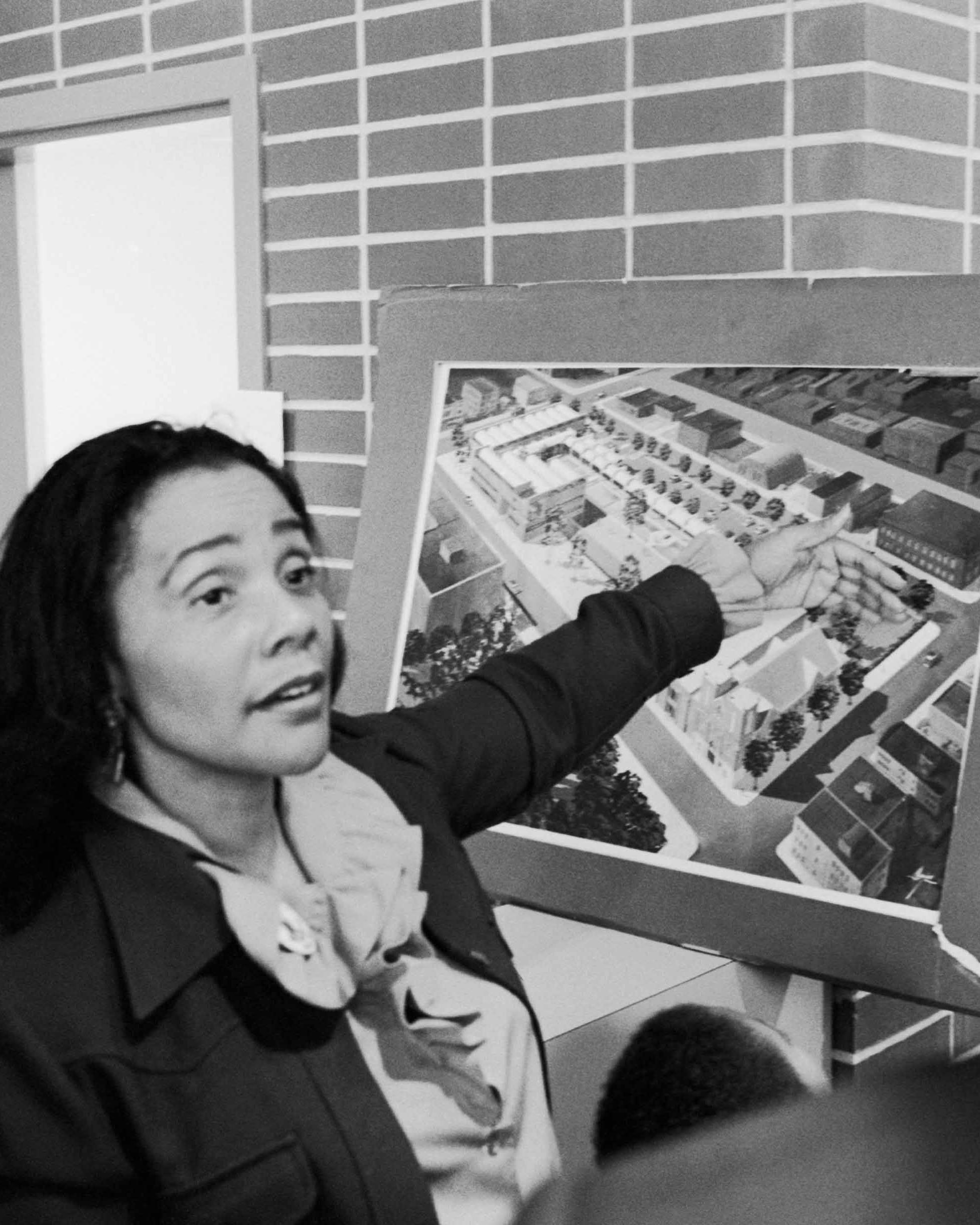 Coretta Scott King gestures at an architectural rendering of the Martin Luther King Jr., Center for Nonviolent Social Change.